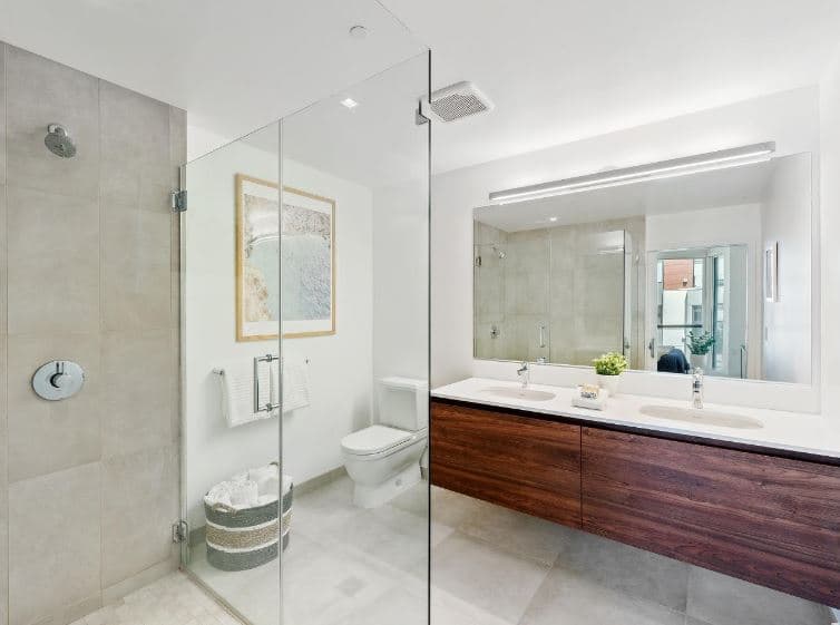 Tiled showers and dark wood cabinetry work together to elevate the appearance of the bathrooms in 815 Tennessee.