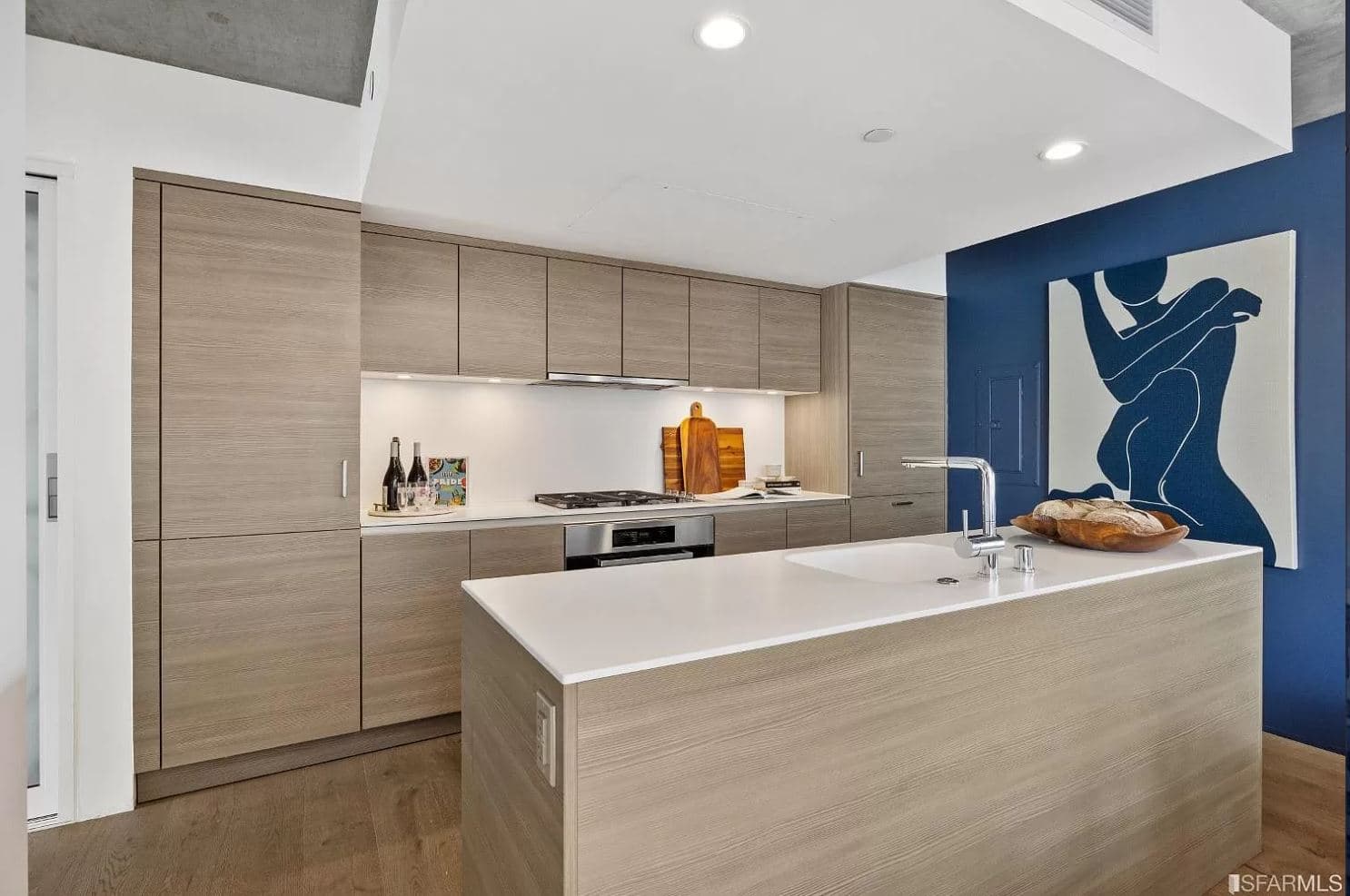 Sleek countertops and custom wood-paneled cabinetry help elevate the appearance of the kitchens in 8 Octavia, while the stainless steel gas range and stove tops help elevate the kitchen experience.