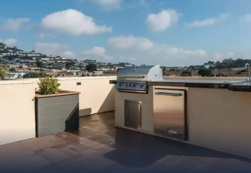 Residents at the Crimson have access to a roof deck that not only includes a firepit but a outdoor dining area and barbecue as well.