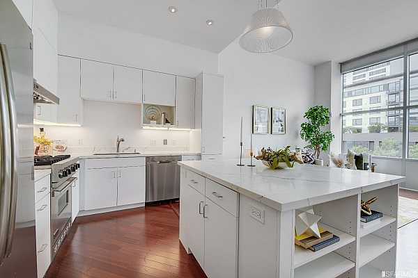 Quartz countertops and high-end, stainless steel appliances work together to boast a gourmet kitchen complete with plentiful cabinetry.
