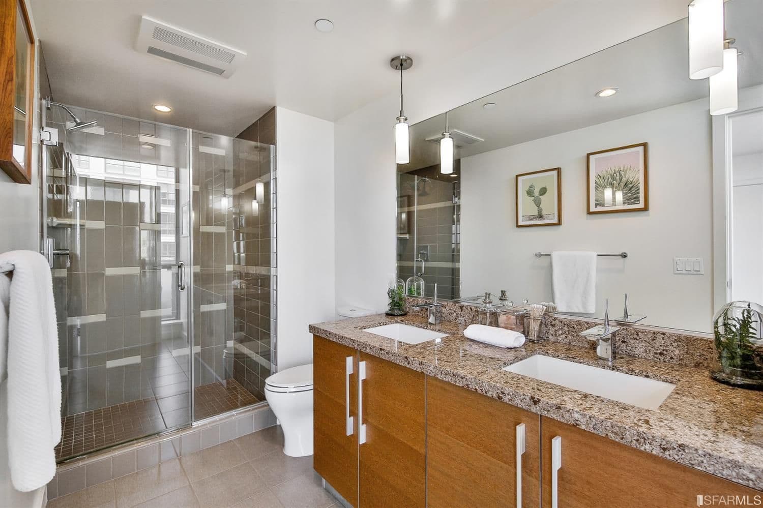 The bathrooms are designed with the Madrone's resort-style aesthetic in mind, with a natural color palette and Caesarstone countertops.