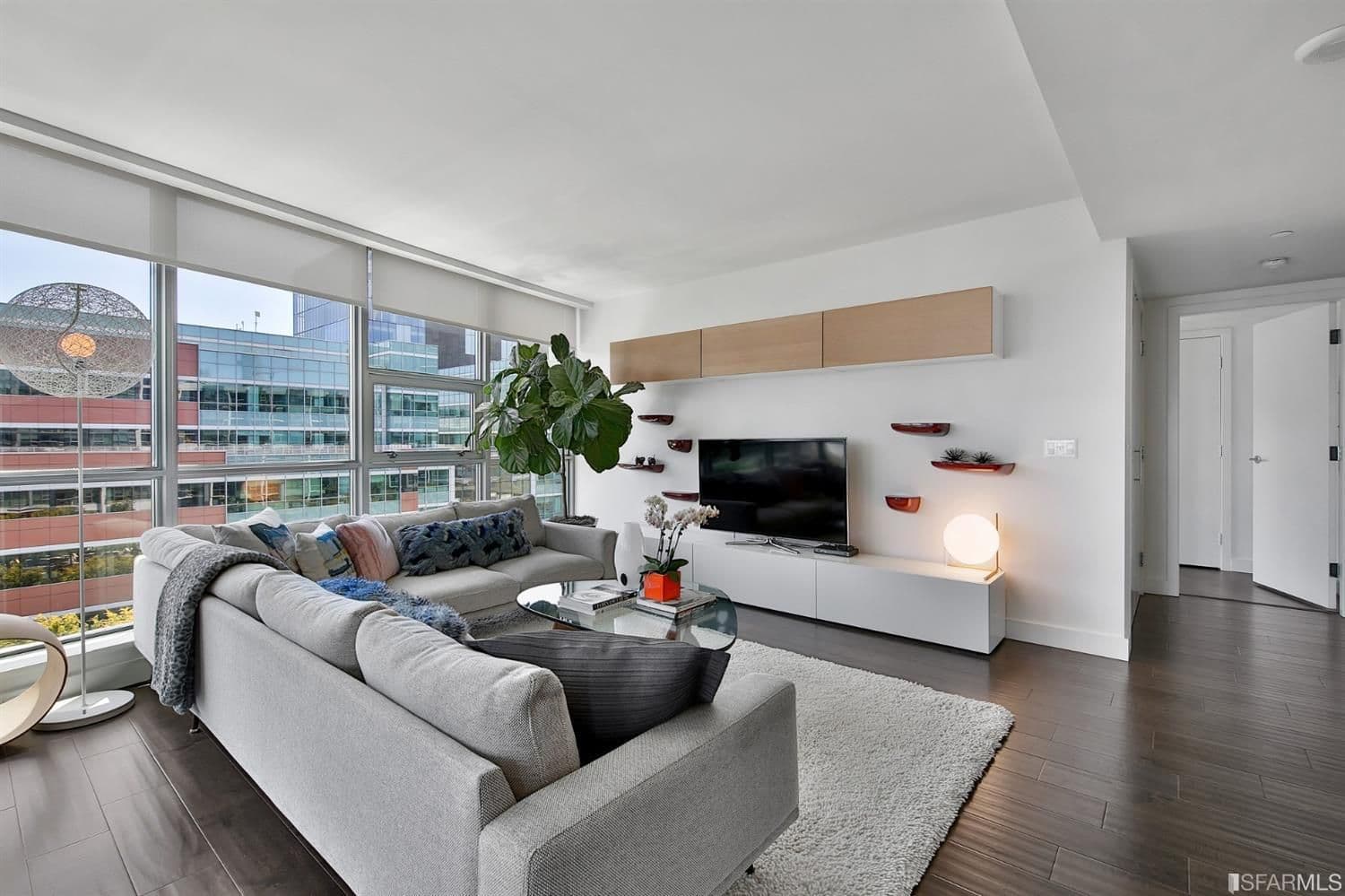 Dark wood flooring, large windows, and spacious design can be easily utilized by residents when setting out furniture and decor. 