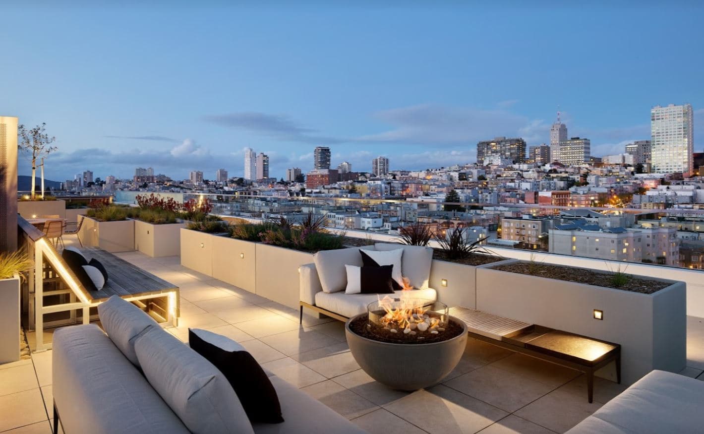 The rooftop terrace of The Austin has lounge seating, gas firepits, and panoramic views that are sure to make a good night a great night for anyone.