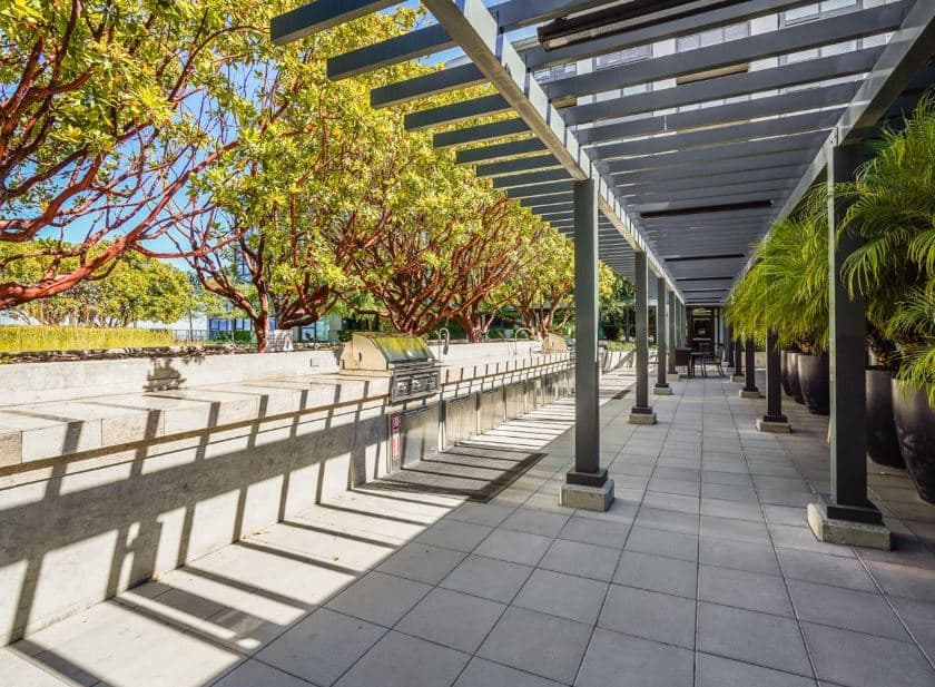 The structure is topped with a massive rooftop terrace that contains a landscaped courtyard, barbecues, lounge seating, and firepits. 