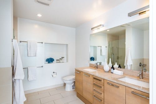 Bathrooms are additionally adorned with Studio Becker cabinetry, porcelain-tiled shower-over-baths, and porcelain toilets and sinks. 