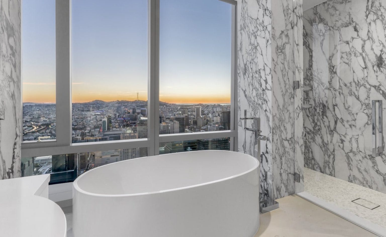 With a lavish marble walls and a centerpiece tub, the bathrooms are relaxing, clean, and classy. Photo courtesy of the 181 Fremont website. 