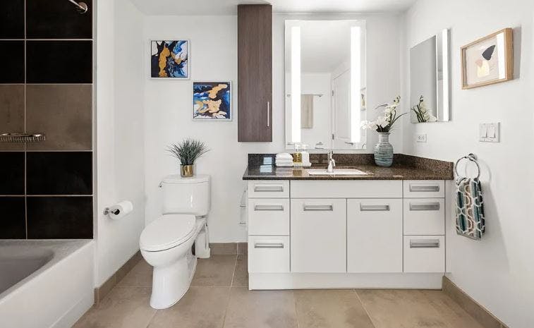 The tiled bathrooms, porcelain toilet and sink, and shower-over-bath designs are all included in residences of Arterra. 