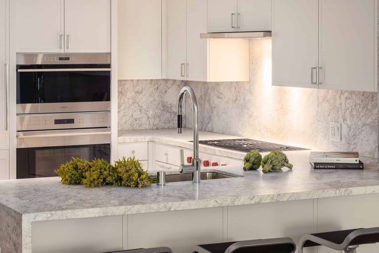 The kitchens in Crescent Nob Hill have custom cabinetry, marble countertops, and backsplashes that come together to boast a sleek and opulent appearance. 