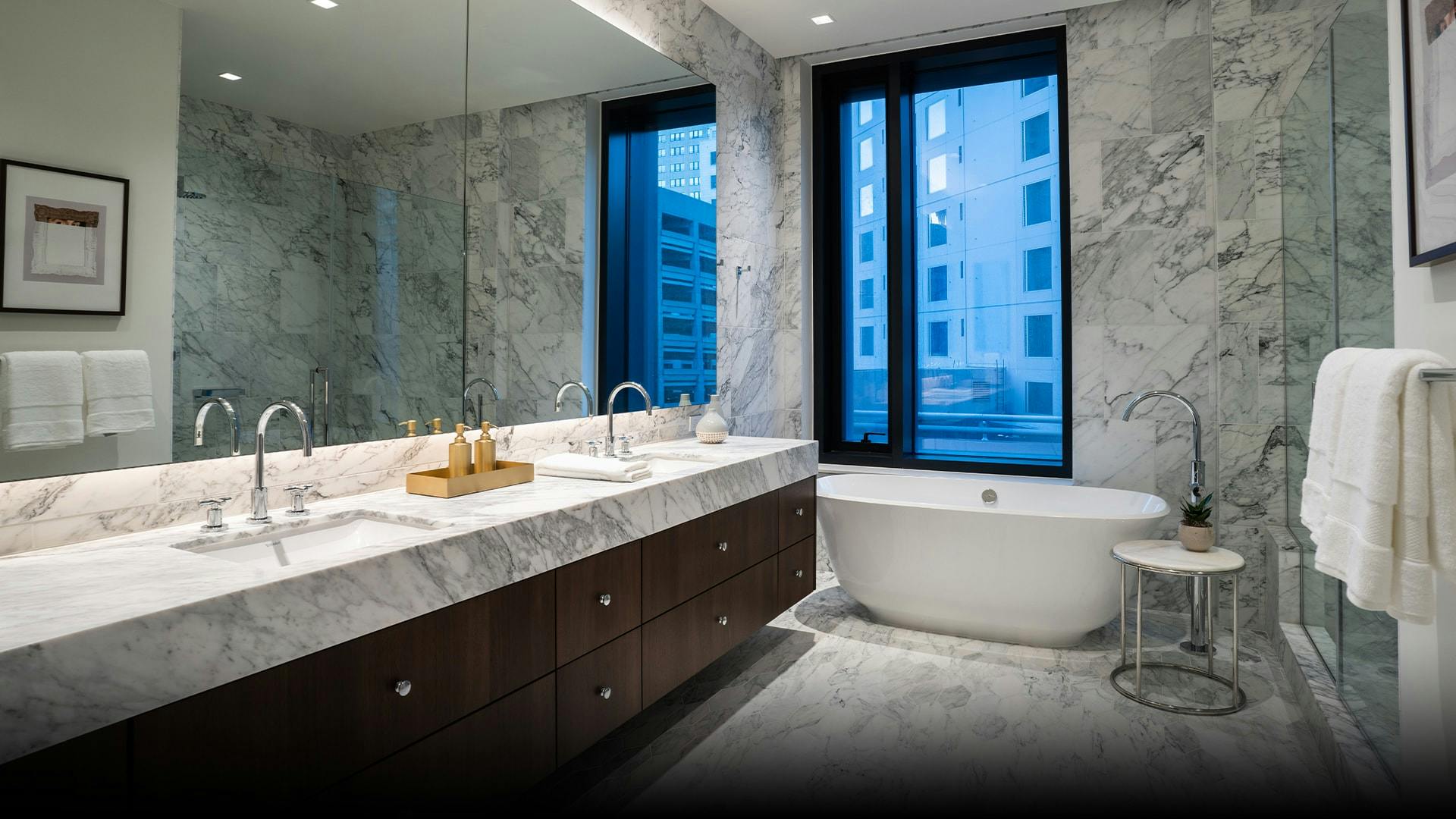 The master bathrooms in Aronson are adorned with arabescato marble and German milled cabinetry. They are complete with a free-standing Victora & Albut Amiata tub as a centerpiece. 