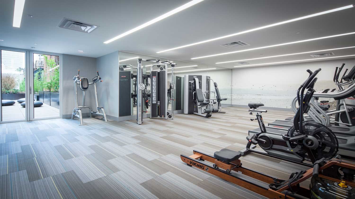 One of the many amenities offered at 99 Rausch is a fully-equipped gym room with weight machines and running equipment. 